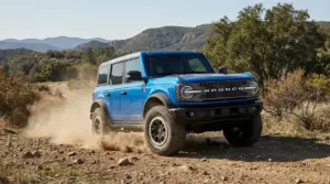 Fuoristrada sportivo blu su strada sterrata in mezzo alla natura