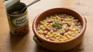 Piatto di pasta e fagioli in ciotola di terracotta con barattolo di fagioli borlotti